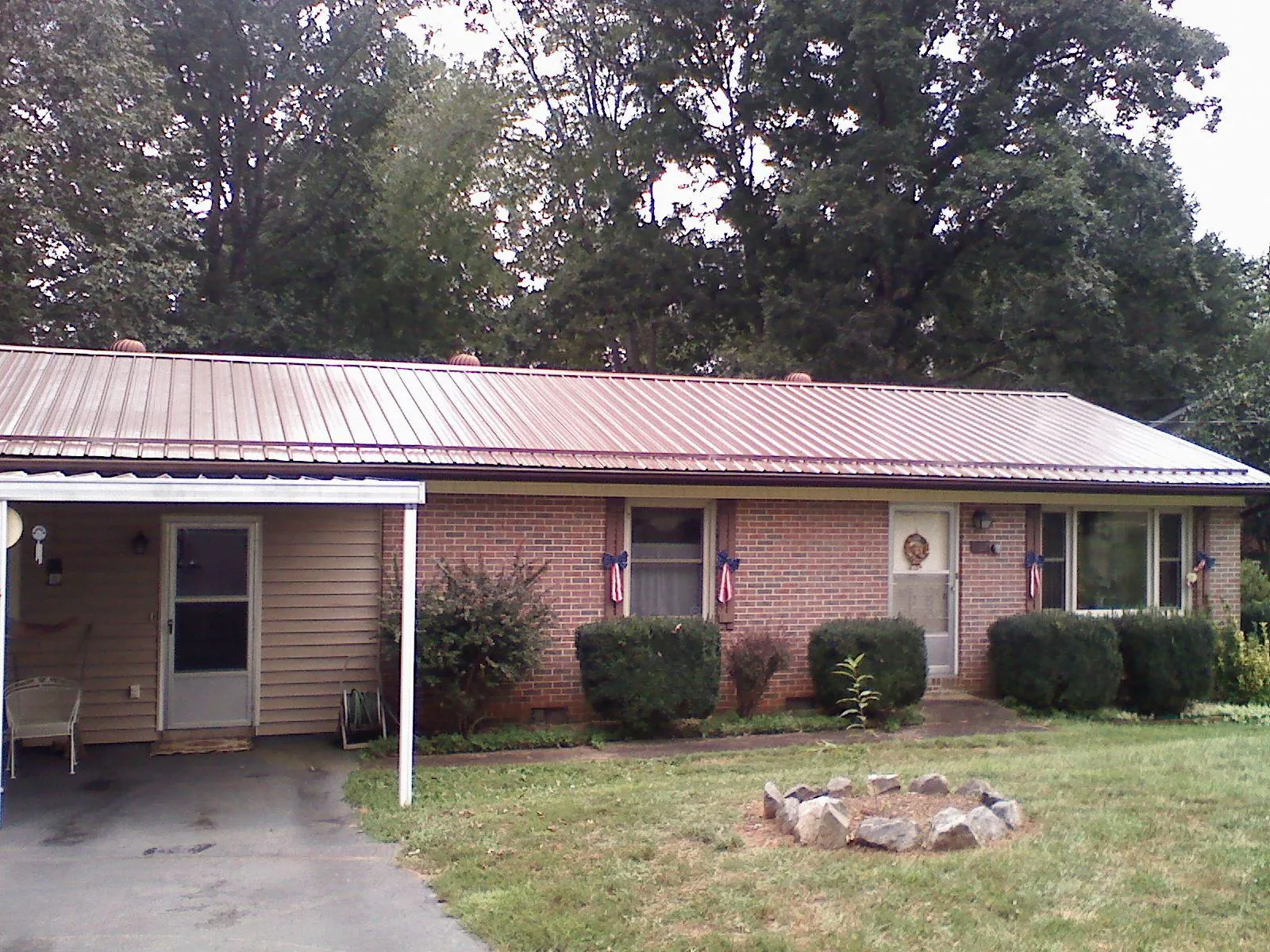 Bronze metal roof and carport on a brick ranch home — Roof Repair work by our crew in Cedar Knolls