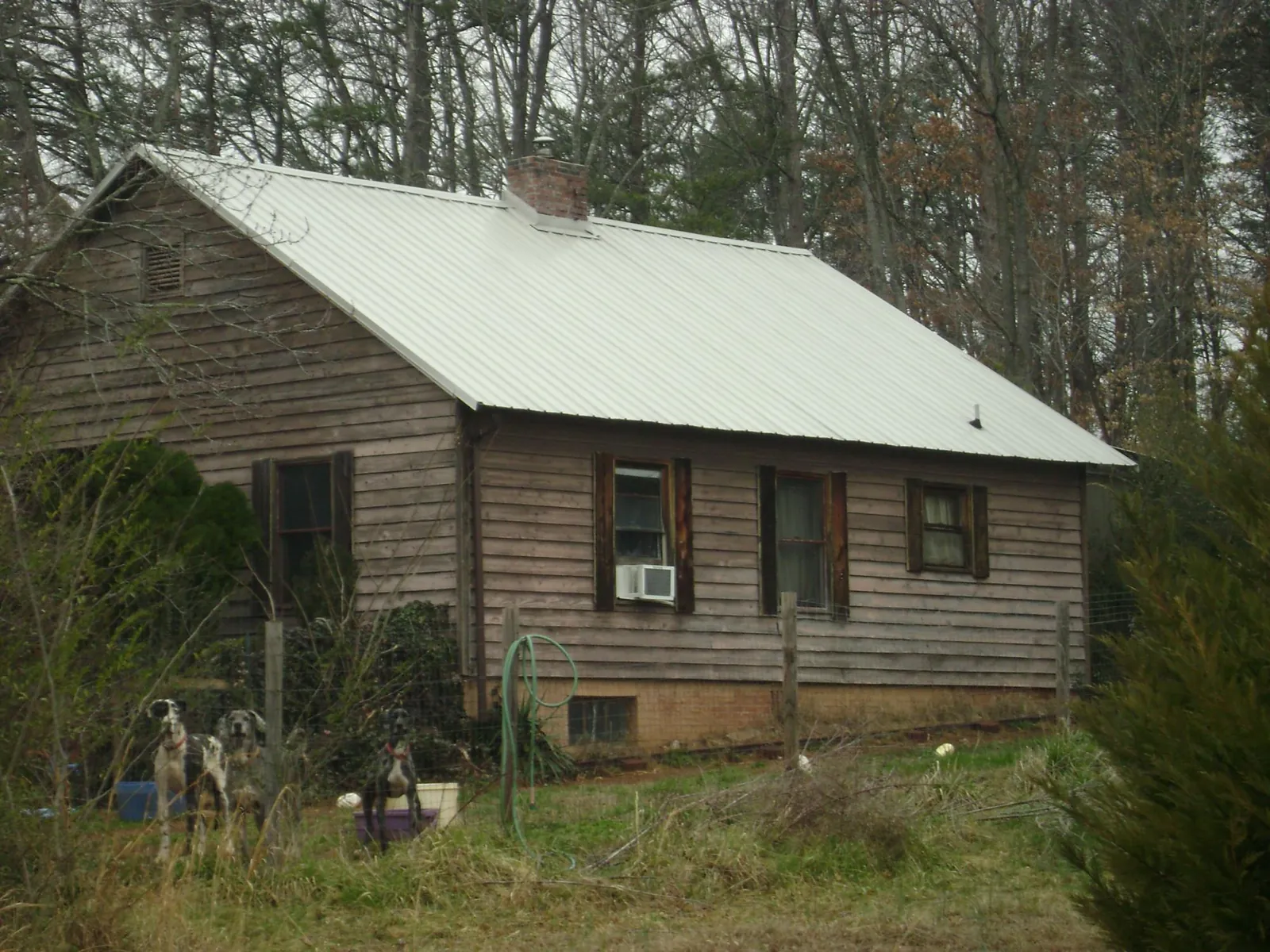 White metal roof on an old wood sided farmhouse, from a Metal Roof Installation job in Cedar Knolls